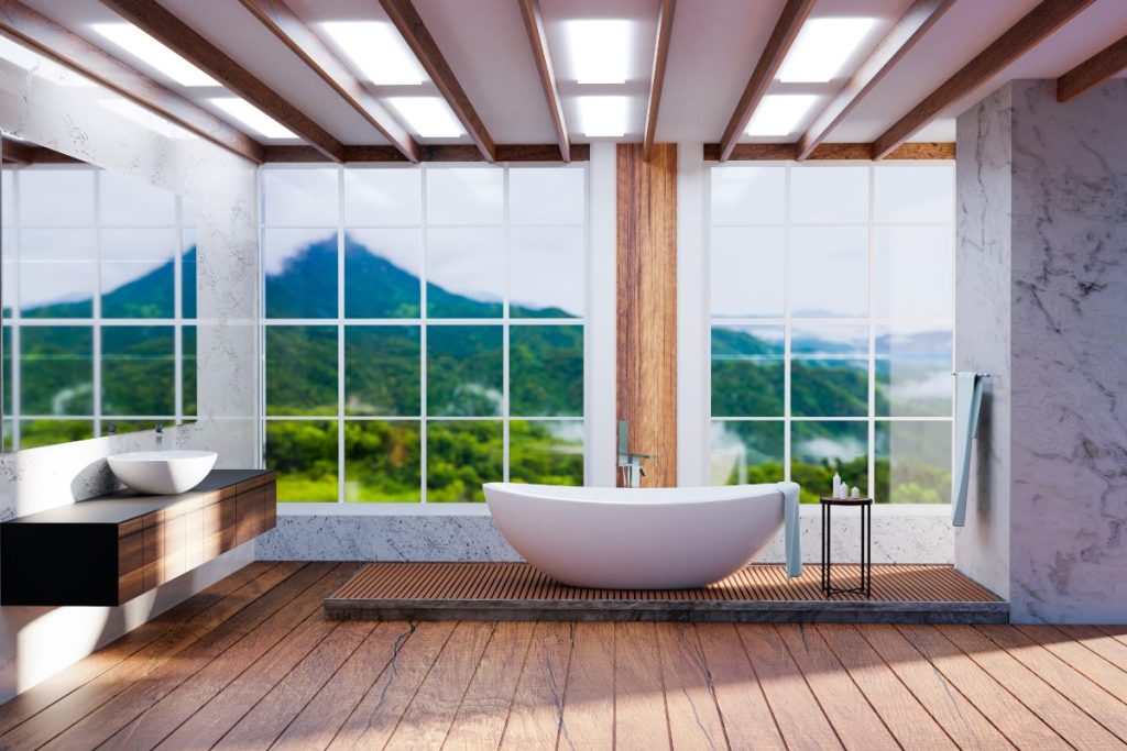 Une salle de bain éclairée avec un baignoire installé