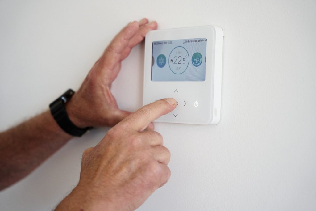Mains ajustant le thermostat 